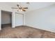 Spacious living room featuring soft carpeting, a ceiling fan, and ample space at 13337 W Evans Dr, Surprise, AZ 85379