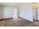 Open living room with neutral tones and plush carpeting at 13337 W Evans Dr, Surprise, AZ 85379