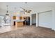 Open floorplan combines the kitchen and living room with tile and carpet flooring at 13337 W Evans Dr, Surprise, AZ 85379