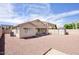 Spacious backyard with desert landscaping, patio, and storage shed at 13414 W Maui Ln, Surprise, AZ 85379