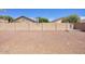 Low maintenance backyard features desert landscaping and block fence at 13414 W Maui Ln, Surprise, AZ 85379