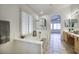 Modern bathroom with a soaking tub and natural light from large windows at 13414 W Maui Ln, Surprise, AZ 85379