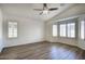 Spacious bedroom featuring a ceiling fan and multiple windows for natural light at 13414 W Maui Ln, Surprise, AZ 85379