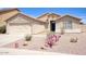 Charming single-story home with desert landscaping and a two-car garage on a sunny day at 13414 W Maui Ln, Surprise, AZ 85379