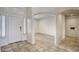 Bright entryway featuring neutral tile flooring, arched doorways, and an adjacent living space at 13414 W Maui Ln, Surprise, AZ 85379