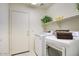 This laundry room features a washer and dryer, and a shelf at 13414 W Maui Ln, Surprise, AZ 85379