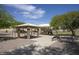 Community park featuring a covered picnic area, playground, and benches at 13414 W Maui Ln, Surprise, AZ 85379