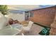 Covered backyard patio with seating, rug, and landscaped yard at 1520 W Encanto Blvd, Phoenix, AZ 85007