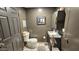 Bathroom with modern dark brown cabinets, a white toilet, and a framed artwork at 1520 W Encanto Blvd, Phoenix, AZ 85007