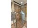 Bathroom featuring a shower with tile surround, glass doors, and modern fixtures at 1520 W Encanto Blvd, Phoenix, AZ 85007