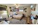 Spacious bedroom featuring a queen bed, a study desk, and wall decorations at 1520 W Encanto Blvd, Phoenix, AZ 85007