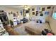 Bright bedroom featuring a queen bed, a study desk, and wall decorations at 1520 W Encanto Blvd, Phoenix, AZ 85007