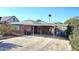 Charming single-story brick home featuring a covered carport and a well-maintained front yard at 1520 W Encanto Blvd, Phoenix, AZ 85007