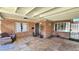 Cozy covered porch with a brick facade, decorative touches, and comfortable seating area at 1520 W Encanto Blvd, Phoenix, AZ 85007