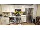Modern kitchen with stainless steel appliances, white cabinets, and ample counter space for cooking and entertaining at 1520 W Encanto Blvd, Phoenix, AZ 85007