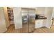 Bright kitchen featuring stainless steel refrigerator, white cabinets, and a convenient pantry for ample storage at 1520 W Encanto Blvd, Phoenix, AZ 85007