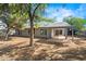 Large backyard featuring desert landscaping, a covered patio, and brick accents at 16412 N 33Rd Ave, Phoenix, AZ 85053