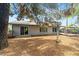View of a large backyard featuring desert landscaping, a covered patio, and large sliding glass doors at 16412 N 33Rd Ave, Phoenix, AZ 85053