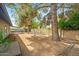 Large backyard featuring desert landscaping, with wood border, a covered patio and a brick wall at 16412 N 33Rd Ave, Phoenix, AZ 85053