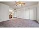 Spacious bedroom boasts a ceiling fan and convenient access to the closet and bathroom at 16412 N 33Rd Ave, Phoenix, AZ 85053