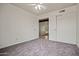 Carpeted bedroom features a ceiling fan and closets providing convenient access to other rooms at 16412 N 33Rd Ave, Phoenix, AZ 85053