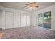 Bedroom offers a ceiling fan and sliding glass door leading to the outdoor space at 16412 N 33Rd Ave, Phoenix, AZ 85053