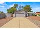 Charming single-Gathering home featuring desert landscaping, an attached two-car garage, and an enclosed courtyard entrance at 16412 N 33Rd Ave, Phoenix, AZ 85053