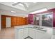 Bright kitchen with gray counters and a breakfast bar, flowing to a spacious living area at 16412 N 33Rd Ave, Phoenix, AZ 85053
