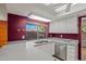 Kitchen with gray counters, a stainless steel dishwasher, and a bright window overlooking the backyard at 16412 N 33Rd Ave, Phoenix, AZ 85053