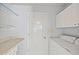 Practical laundry room with ample storage and a convenient washer and dryer setup at 16412 N 33Rd Ave, Phoenix, AZ 85053