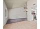 Spacious living room featuring carpeted and tiled areas with a seamless transition to the open-concept kitchen at 16412 N 33Rd Ave, Phoenix, AZ 85053