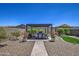 Beautiful backyard with a covered patio, seating, potted plants, and well-manicured landscaping at 16781 S 181St Ln, Goodyear, AZ 85338