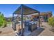 Entertain outdoors with a complete kitchen and dining area under the shaded backyard patio at 16781 S 181St Ln, Goodyear, AZ 85338