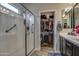 Modern bathroom with a glass-enclosed shower and a walk-in closet, offering convenience and functionality at 16781 S 181St Ln, Goodyear, AZ 85338