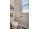 Bathroom featuring a toilet with grab bars for safety and convenience, ensuring accessibility for all at 16781 S 181St Ln, Goodyear, AZ 85338