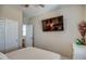 Bright bedroom showcases a mounted television, closet, and a neutral color scheme at 16781 S 181St Ln, Goodyear, AZ 85338