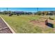 A grassy community park with wooden play structures and landscaping at 16781 S 181St Ln, Goodyear, AZ 85338