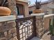 Close up of a decorative courtyard gate with desert landscaping in the background at 16781 S 181St Ln, Goodyear, AZ 85338