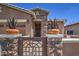 Beautiful front gate entrance with stone pillars and decorative planters, adding curb appeal at 16781 S 181St Ln, Goodyear, AZ 85338