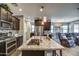 Modern kitchen with granite countertops, stainless steel appliances, and an island with a sink at 16781 S 181St Ln, Goodyear, AZ 85338
