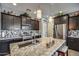 Bright kitchen featuring granite counters, stainless steel appliances, and modern pendant lighting above the island at 16781 S 181St Ln, Goodyear, AZ 85338