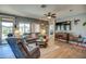 Bright living room featuring wood floors, a ceiling fan, comfortable seating and a view of the backyard at 16781 S 181St Ln, Goodyear, AZ 85338