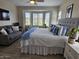 Bright bedroom with large windows, a comfortable bed, and a seating area, providing a relaxing retreat at 16781 S 181St Ln, Goodyear, AZ 85338