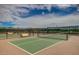 Outdoor pickle ball court featuring fences, nets, and bench seating at 16781 S 181St Ln, Goodyear, AZ 85338