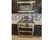 Stainless steel gas range featuring five burners, digital interface, and convection oven at 16781 S 181St Ln, Goodyear, AZ 85338
