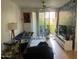 Cozy living room features a ceiling fan and sliding glass doors opening to the outside at 1701 E Colter St # 264, Phoenix, AZ 85016