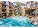 Inviting pool area with lounge chairs, surrounded by manicured landscaping and palm trees at 1701 E Colter St # 264, Phoenix, AZ 85016