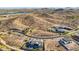 Picturesque aerial view of luxury homes nestled in a desert landscape with a lake and mountain in the background at 17837 W Estes Way, Goodyear, AZ 85338