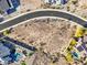 An aerial view of desert land available for building with neighborhood pools and modern homes at 17837 W Estes Way, Goodyear, AZ 85338