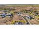 An aerial view of luxury homes in a desert landscape, featuring well-maintained roads and scenic surroundings at 17837 W Estes Way, Goodyear, AZ 85338
